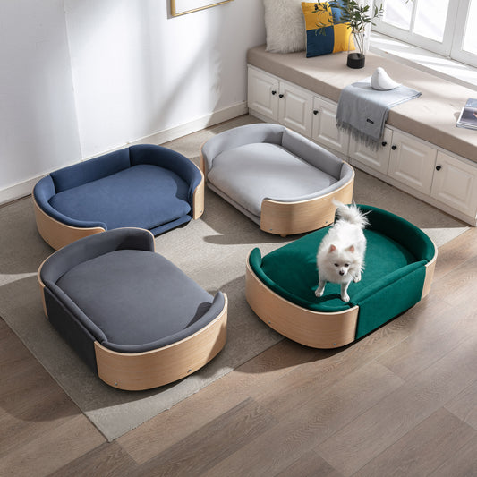 Multiple circular pet beds with black bent wood and velvet padding, arranged in a home setting. One bed is shown with a white dog sitting on it.